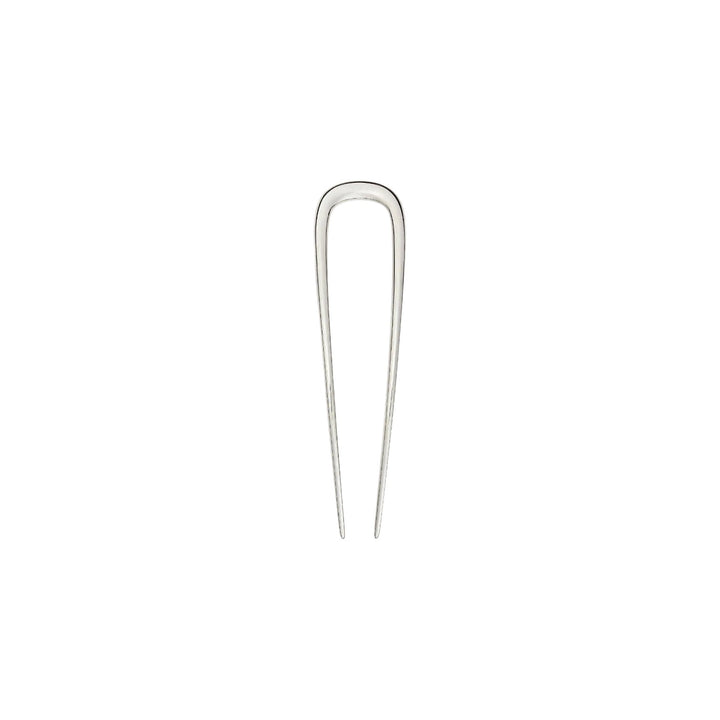 The Tiny Finch 5-inch handcrafted silver stainless steel French hair pin for updos on a neutral background.