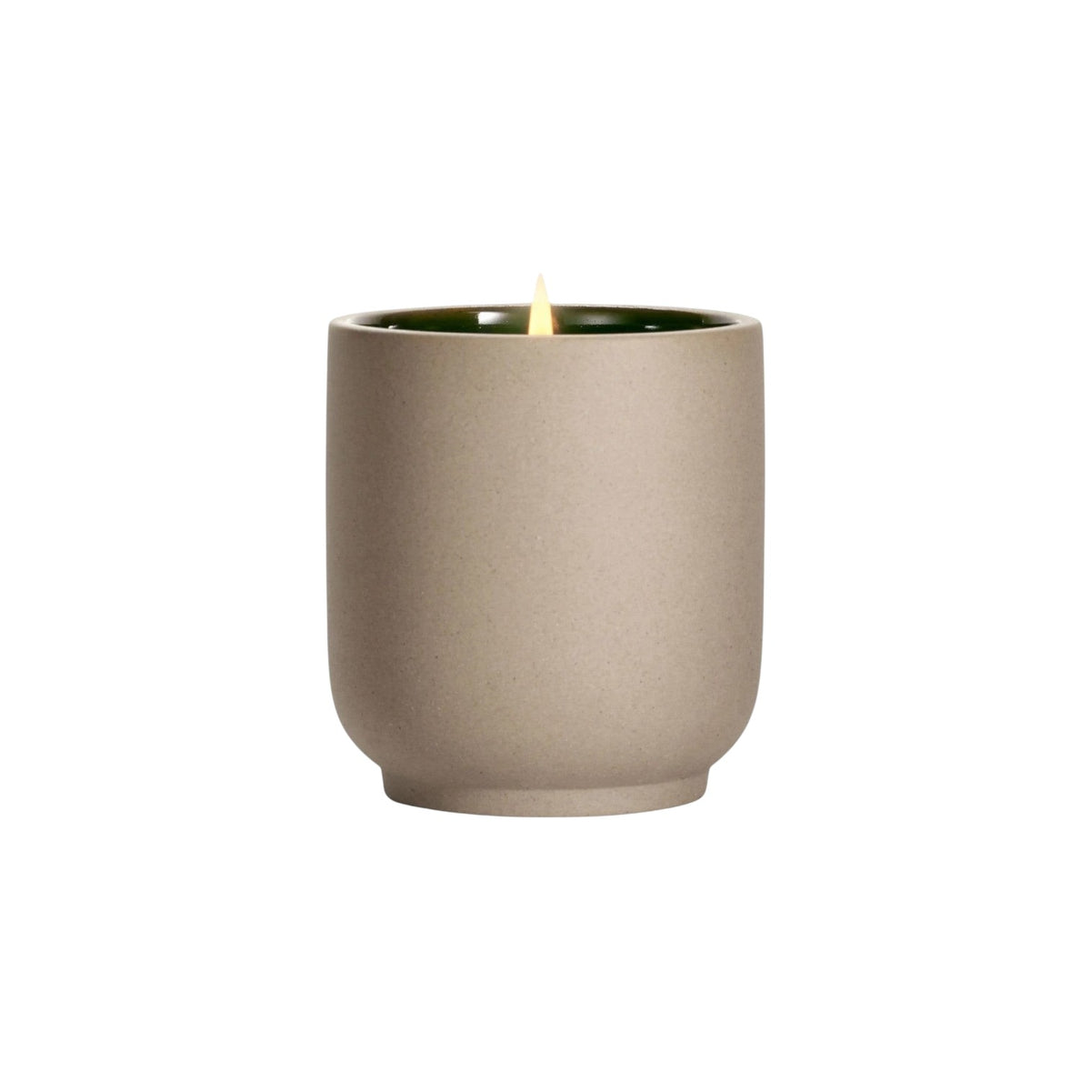 The Tiny Finch Steeped Rose candle in a matte beige kiln-fired ceramic vessel with a green interior and lit wick.