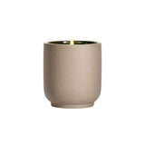 The Tiny Finch Steeped Rose candle in a matte beige kiln-fired ceramic vessel with a green interior and lit wick.