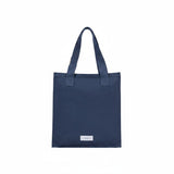 The Tiny Finch storm blue organic cotton canvas tote bag with a secure zip closure and minimalist design.