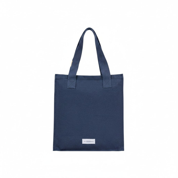 The Tiny Finch storm blue organic cotton canvas tote bag with a secure zip closure and minimalist design.