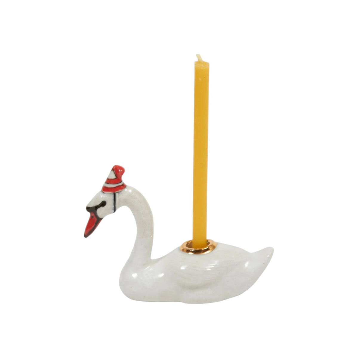 The Tiny Finch white ceramic swan cake topper wearing a red and white party hat with a yellow birthday candle.
