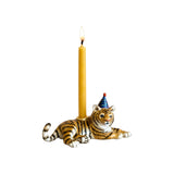 The Tiny Finch hand-painted porcelain tiger cake topper wearing a blue party hat with a yellow birthday candle