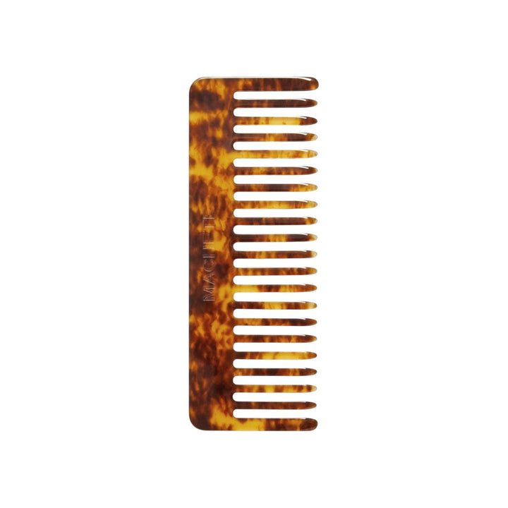The Tiny Finch wide-tooth comb in a brown tortoiseshell pattern, handcrafted from durable Italian acetate.