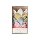 The Tiny Finch tulip-shaped cupcake liners in pastel pink, blue, yellow, and white, packaged in a clear gift box.
