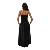 The Tiny Finch Valentina black strapless maxi dress in broderie anglaise with a fitted bodice and A-line skirt.