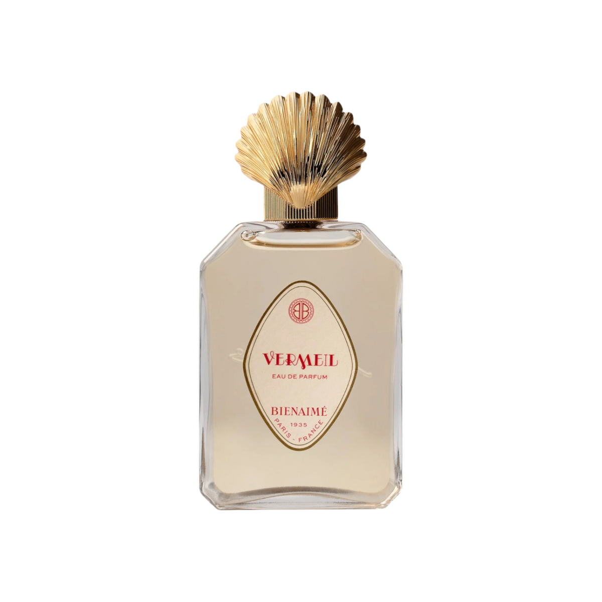 The Tiny Finch Bienaimé Vermeil eau de parfum in a clear glass bottle with a decorative gold shell-shaped cap.