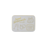 The Tiny Finch Sweet Sentiments keepsake tin with gold-pressed wedding illustrations and text on a white background.