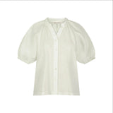 The Tiny Finch Bailey Renee white handwoven linen blouse with raglan sleeves and button-front detail.