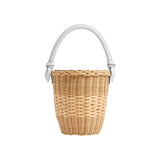 The Tiny Finch Jane Bag in white, a handwoven rattan basket bag with a lizard-embossed leather handle and closure.