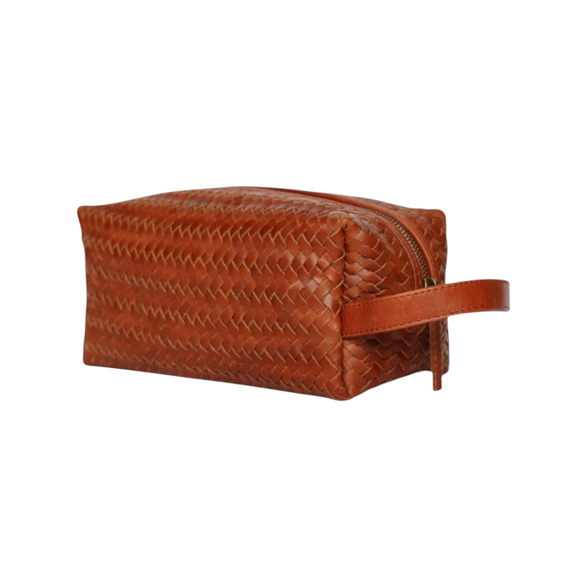 The Tiny Finch woven brown leather dopp kit with a side handle and zipper closure for travel toiletries.