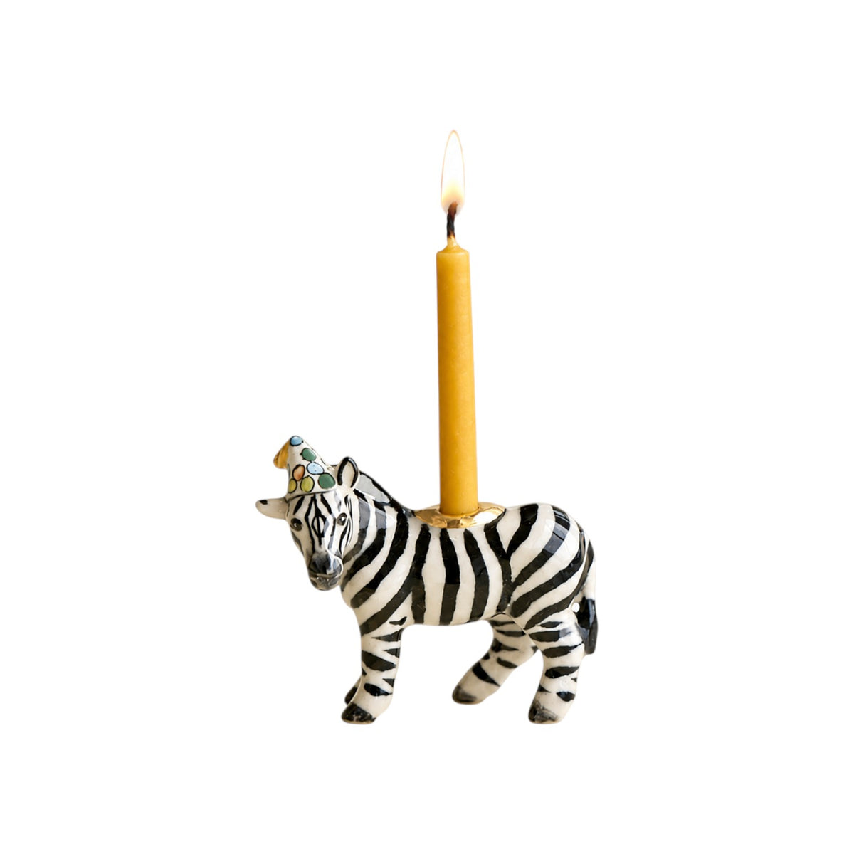 The Tiny Finch zebra party animal cake topper with a lit yellow candle and a colorful patterned party hat
