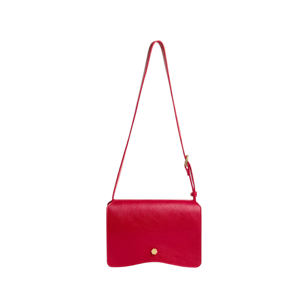 The Tiny Finch Val crossbody bag in carmine red leather with a brass hexagonal clasp and adjustable shoulder strap.